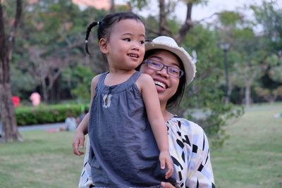 Portrait of happy mother and daughter in park