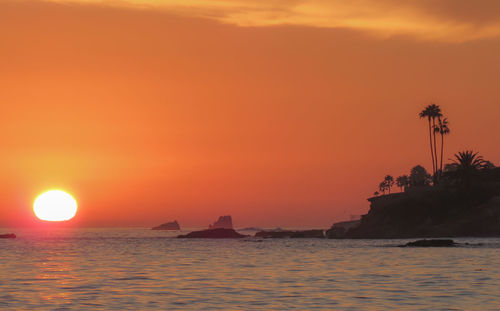 Scenic view of sea against orange sky