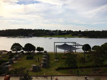 View of boats moored at harbor against sky