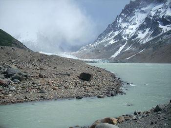 Scenic view of lake and mountains against sky