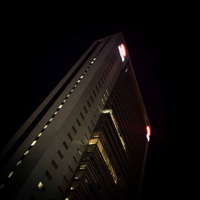 night, illuminated, architecture, built structure, building exterior, low angle view, city, lighting equipment, clear sky, dark, copy space, light - natural phenomenon, modern, no people, building, skyscraper, sky, outdoors, tall - high, high angle view