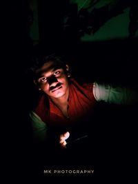 Portrait of young man in darkroom