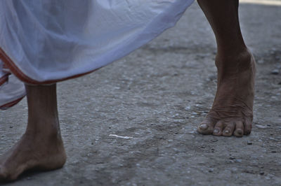 Low section of man standing on ground