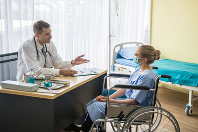 Doctor discussing with patient in hospital