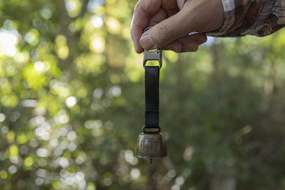 Cropped hand of person holding metal