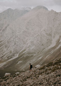 Rear view of man walking down on mountain