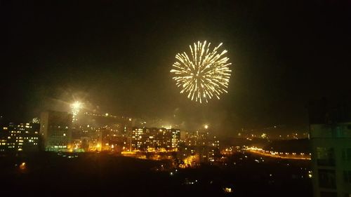 Low angle view of firework display at night