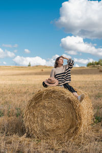 Woman wearing mask on field against sky