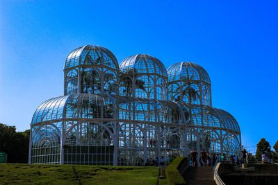 Low angle view of modern building against blue sky