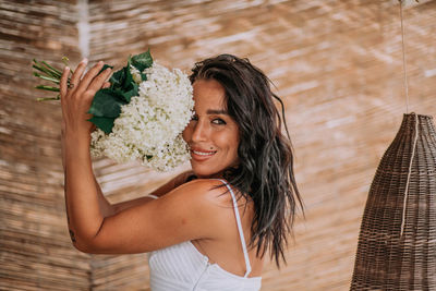 Portrait of a smiling young woman holding umbrella