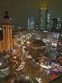 High angle view of city lit up at night