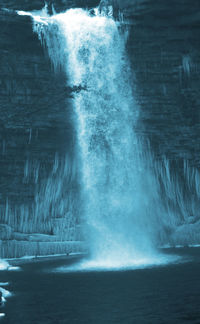 Scenic view of waterfall in sea during winter