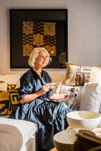 Midsection of woman sitting at home