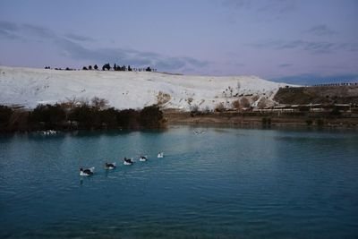 Scenic view of lake with mountains in background