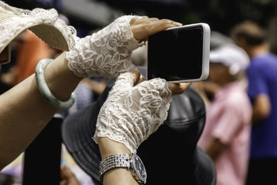 Woman wearing 80s style lace gloves holding a smart phone lace gloves lace gloves lace 