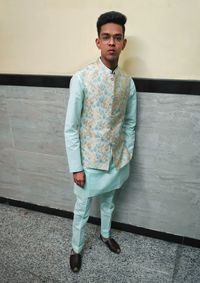 Portrait of young man standing against wall