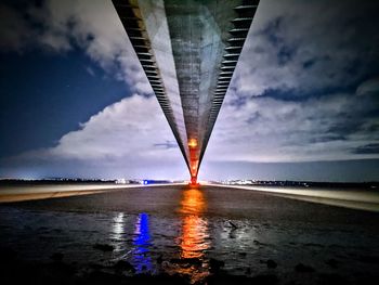 Bridge over sea against sky during sunset
