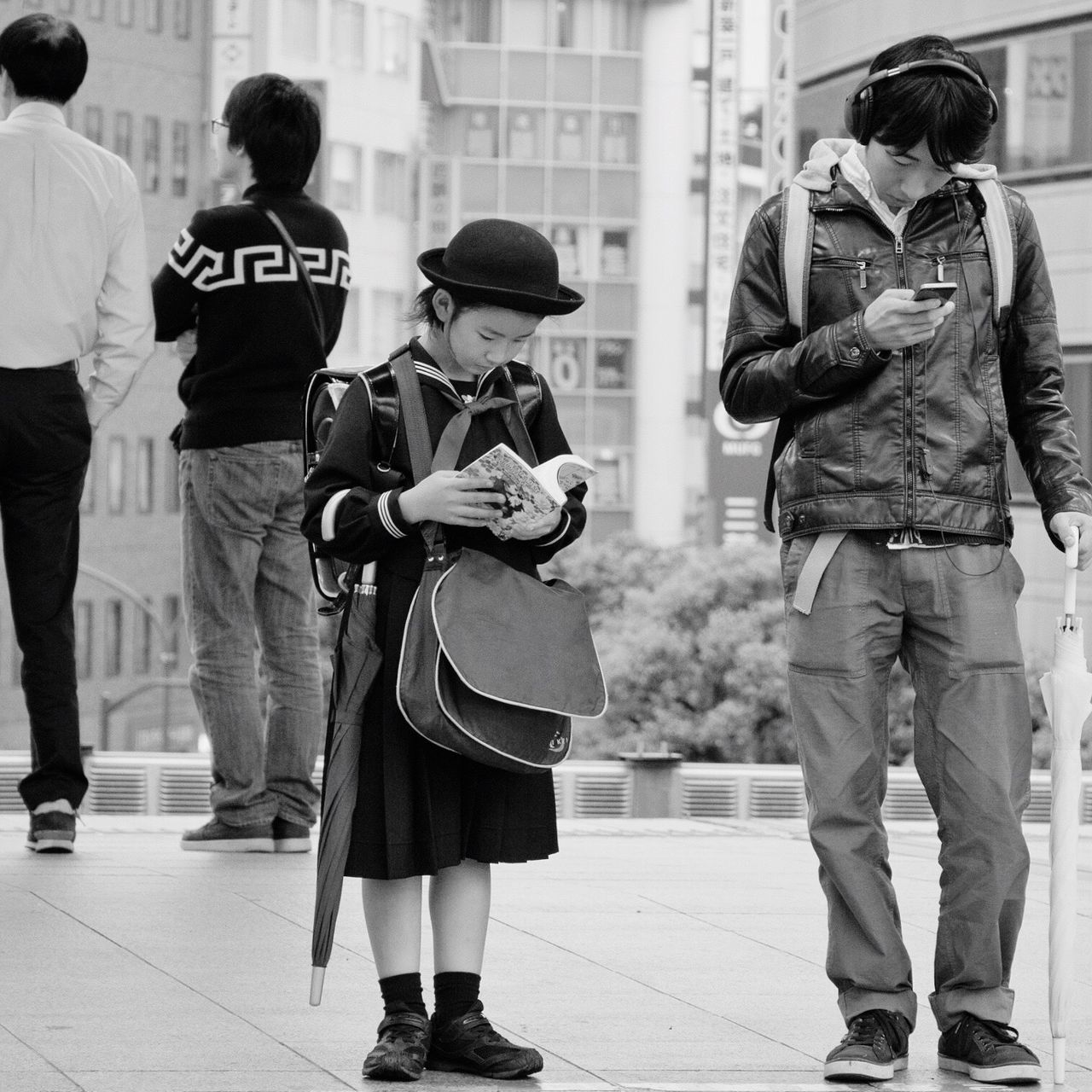 lifestyles, people, casual clothing, full length, walking, leisure activity, rear view, street, togetherness, city, city life, standing, building exterior, medium group of people, person, motion