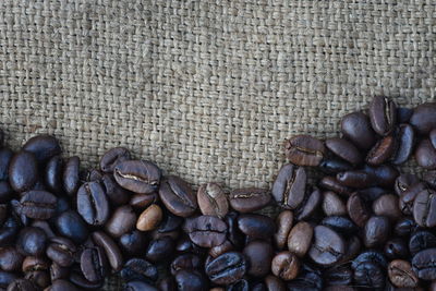 High angle view of roasted coffee beans on jute