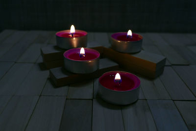 High angle view of lit candles on table