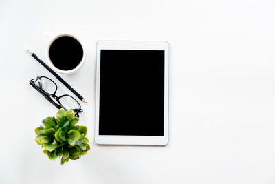 Directly above shot of laptop on table against white background