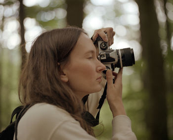 Close-up of woman photographing outdoors