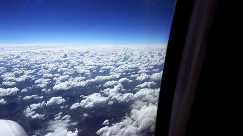Aerial view of clouds seen from airplane window