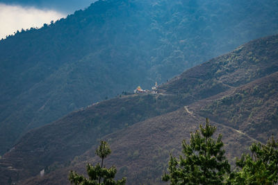 Buddhist monastery situated at mountain foothill at evening 