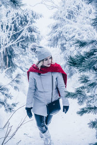 Portrait of smiling young woman in snow