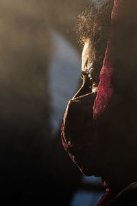 Close-up of mature woman wearing mask standing outdoors