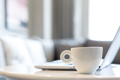 Close-up of coffee cup on table