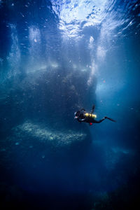 Low angle view of man swimming in sea