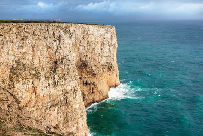 Rock formation on sea against sky