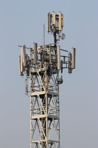 Low angle view of communications tower against clear sky