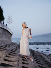 Rear view of woman standing against sea