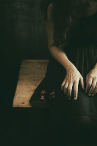 Woman in black dress with dried flowers in her hand ii