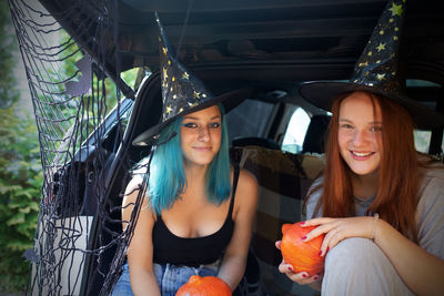 Portrait of smiling woman sitting in car