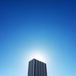 Low angle view of modern buildings against clear blue sky