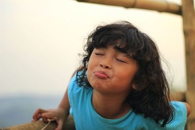 Close-up of girl making face outdoors