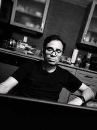 Portrait of young man sitting at home