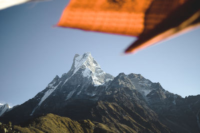 Scenic view of snowcapped mountains against clear sky