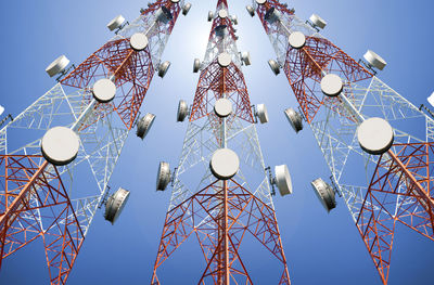 Low angle view of communication tower against clear blue sky