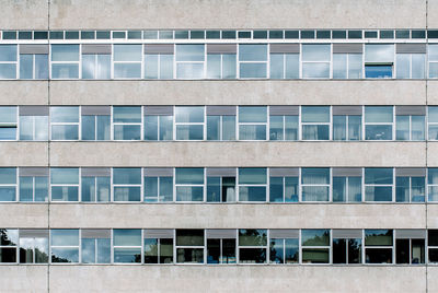 Architecture of office building, exterior, windows, in a row, minimalism, urban.