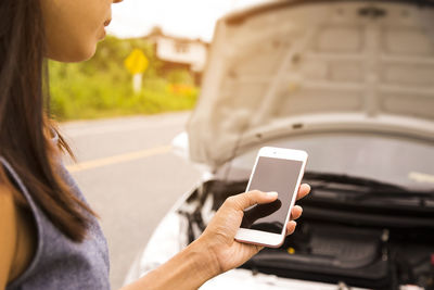 Midsection of woman using mobile phone