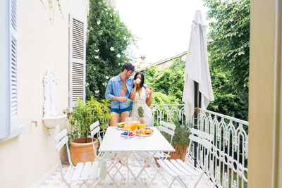 People standing by balcony