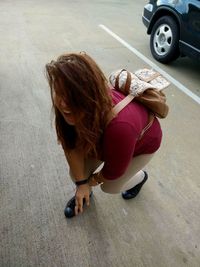 High angle view of girl sitting outdoors