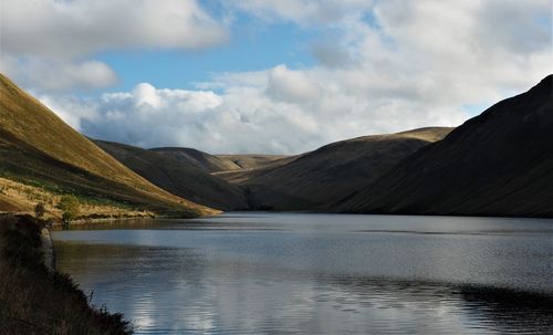 Scenic view of lake and mountains against sky