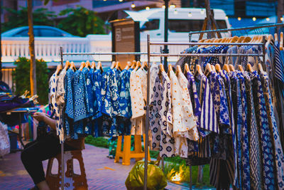 Clothes hanging in market stall for sale