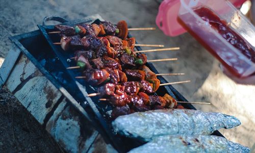 High angle view of meat on barbecue grill