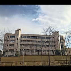 Low angle view of building against cloudy sky